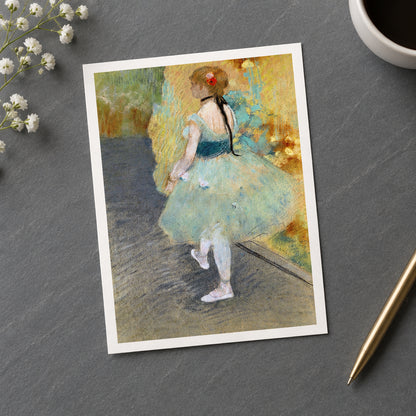 Impressionist-style painting of a young ballerina seen from behind, wearing a pale blue-green tutu with a dark navy bodice and white shoes, standing on a dark floor against a warm yellow and green painted background.