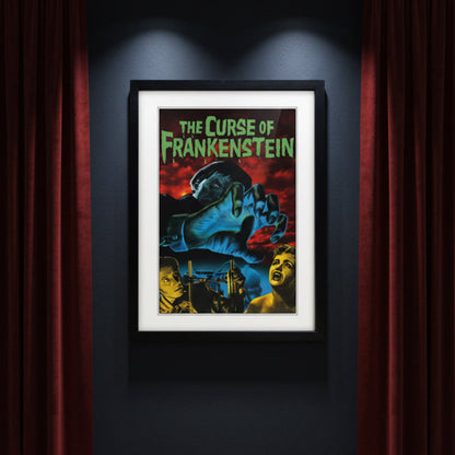 Framed vintage-style poster for 'The Curse of Frankenstein' with a black frame, white mat, and a dramatic illustration featuring a giant blue hand, red sky, and green title text.