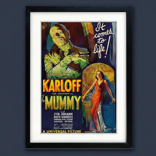 A framed vintage movie poster for the 1927 Universal Pictures film 'The Uncanny Mummy' starring Karl Loeff. The poster features a green mummy monster and a woman in a red dress, with bold yellow and orange title text.