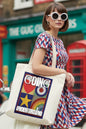 A cream-colored canvas tote bag featuring a colorful graphic print on the front with the words 'GOING UNDERGROUND' and a retro target, star, and rainbow design.