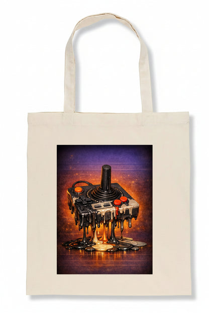 A cream-colored canvas tote bag featuring a large rectangular graphic print of a melting retro video game joystick console on a purple and orange background.