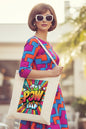 A natural canvas tote bag featuring a colorful pop-art comic book style graphic with the word 'POW' in bold yellow, orange, and pink lettering against a vibrant multicolor burst background.