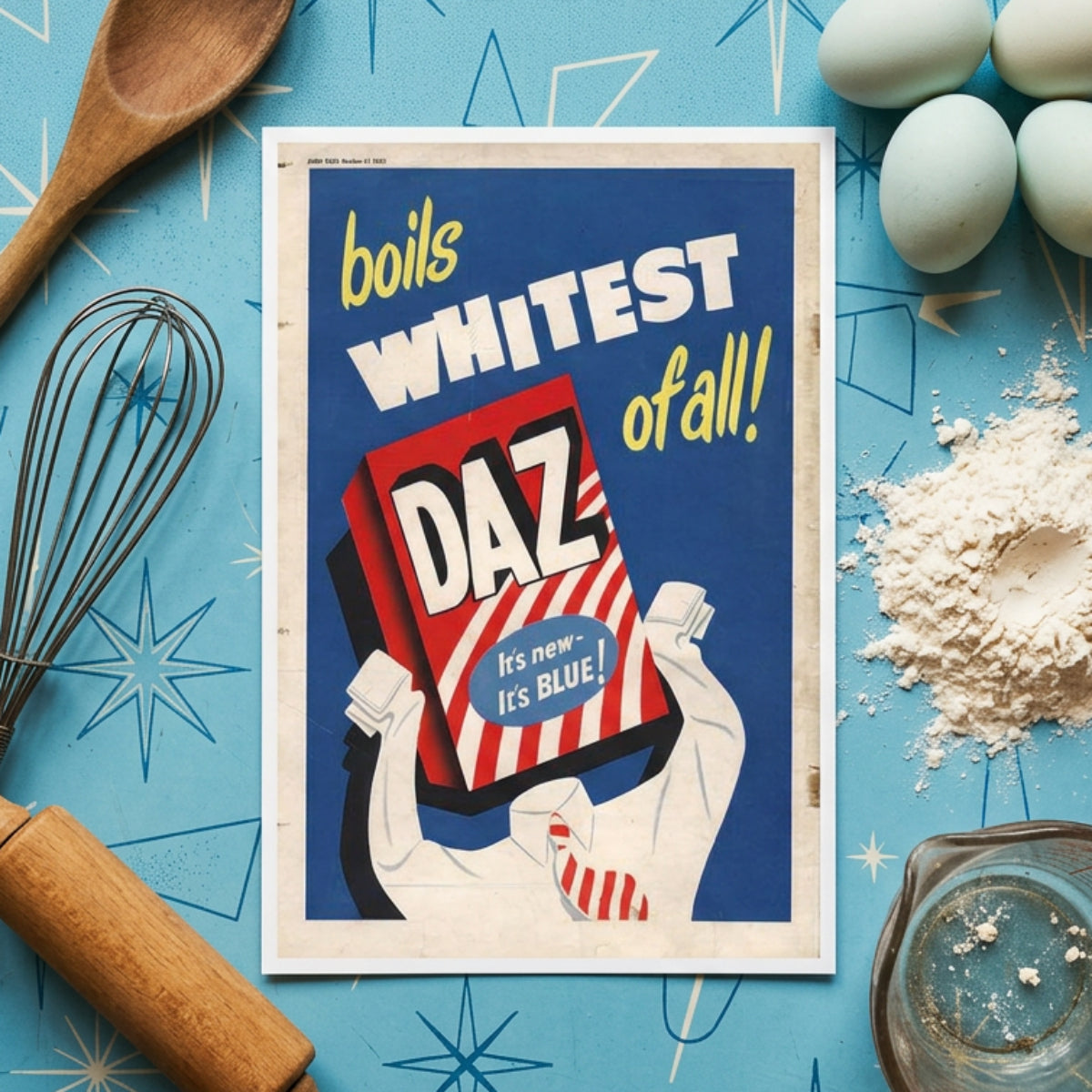 Vintage-style poster artwork with the text 'boils WHITEST of all!' in yellow and white over a blue background, featuring a red-and-white striped box labeled 'DAZ' held by illustrated hands. The poster has aged paper edges and a distressed print look.