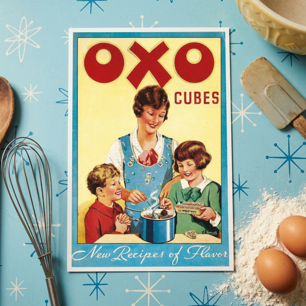 Vintage OXO Cubes box front artwork with large red OXO lettering, a yellow background, a blue border, and an illustration of a woman and two children mixing ice cream in a pot. The text 'New Recipes of Flavor' appears at the bottom.